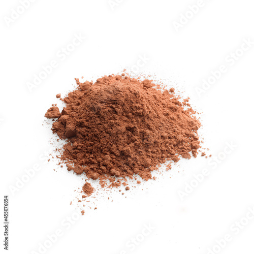 Close up view heap of brown color powder against white background