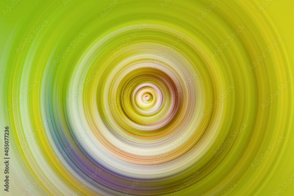 Radiant yellow, green and purple rotating spiral