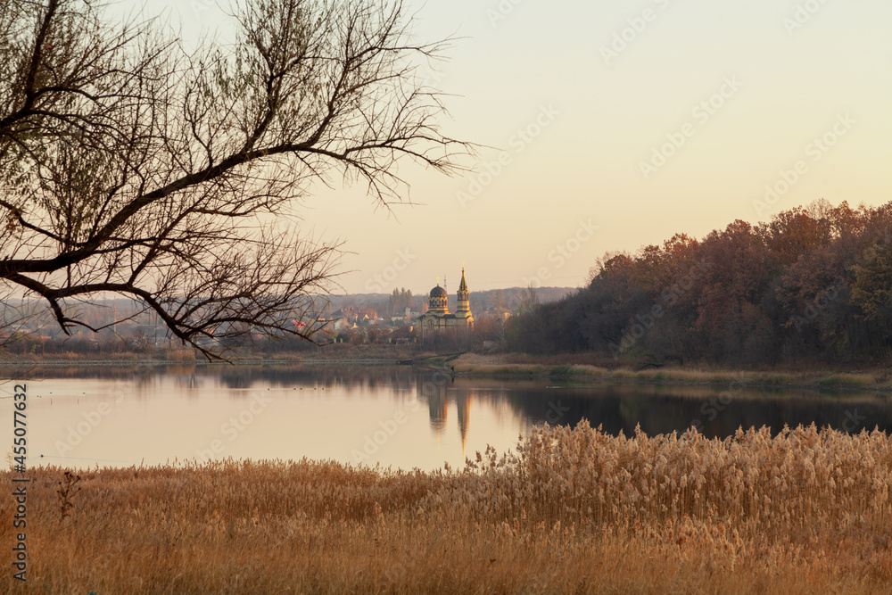 View of autumn lake and church with domes