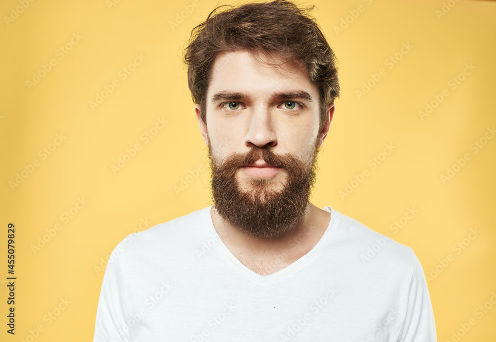 Obraz premium emotional man in a white t-shirt expressive look discontent close-up