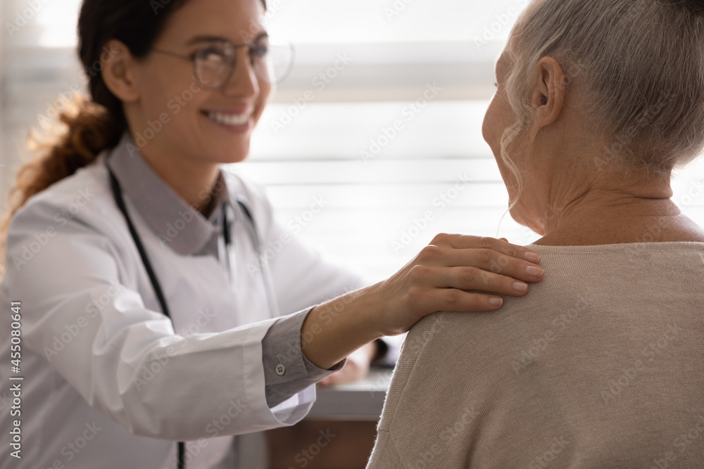 Happy general practitioner telling good optimistic news to older patient, touching shoulder of senior woman, giving support, hope, therapy advice. Successful treatment, geriatric healthcare Happy general practitioner telling good optimistic news to older patient, touching shoulder of senior woman, giving support, hope, therapy advice. Successful treatment, geriatric healthcare