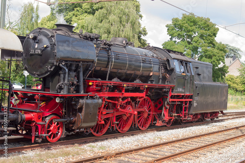 Old historic steam black locomotive with red wheels at station Dieren in the Netherlands