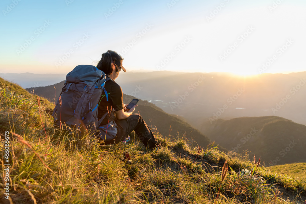 Traveler woman relaxing meditation with serene view mountains. Girl enjoying a view from the top of mountain. Relaxing alone with nature.
