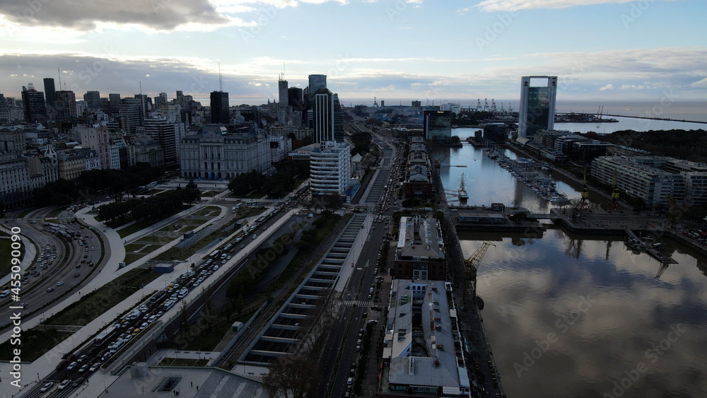 Aerial view over Puerto Madero Waterfront with docking boats in the central business district of Buenos Aires.Río de la Plata riverbank with with skyscraper buildings.