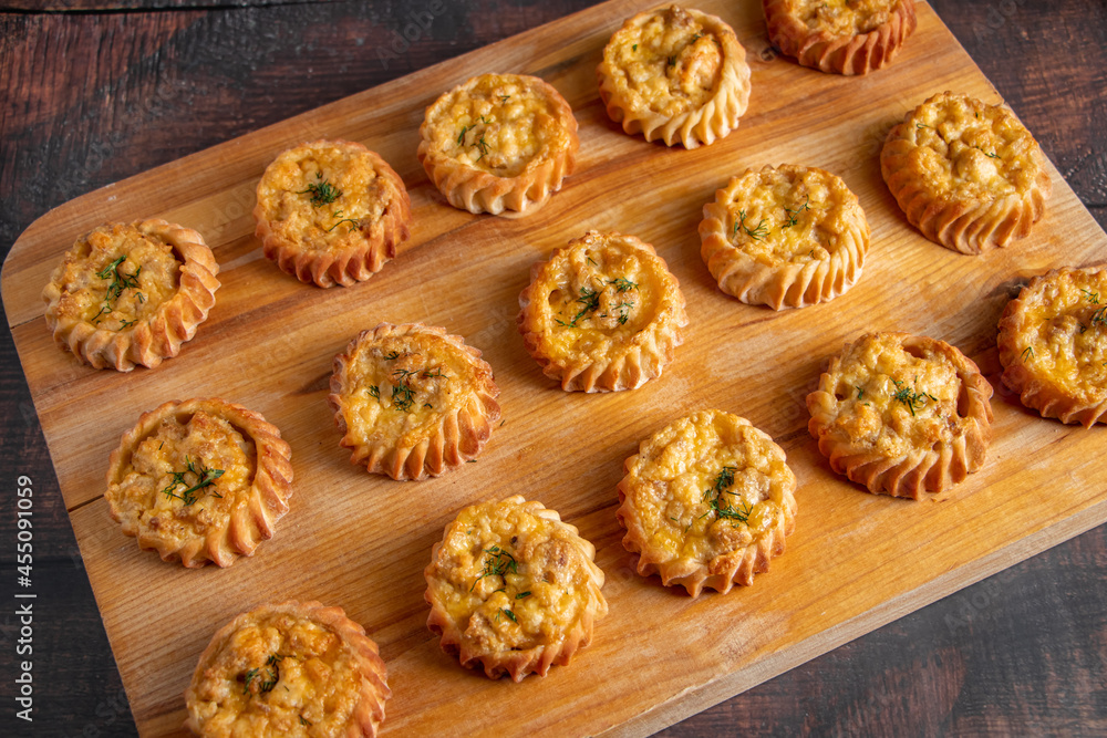 Muffins with vegetables and cheese on wooden board. Fresh homemade cakes for a healthy diet. Preparation of seasonal fall food. Muffins with vegetables and cheese on wooden board. Fresh homemade cakes for a healthy diet. Preparation of seasonal fall food.