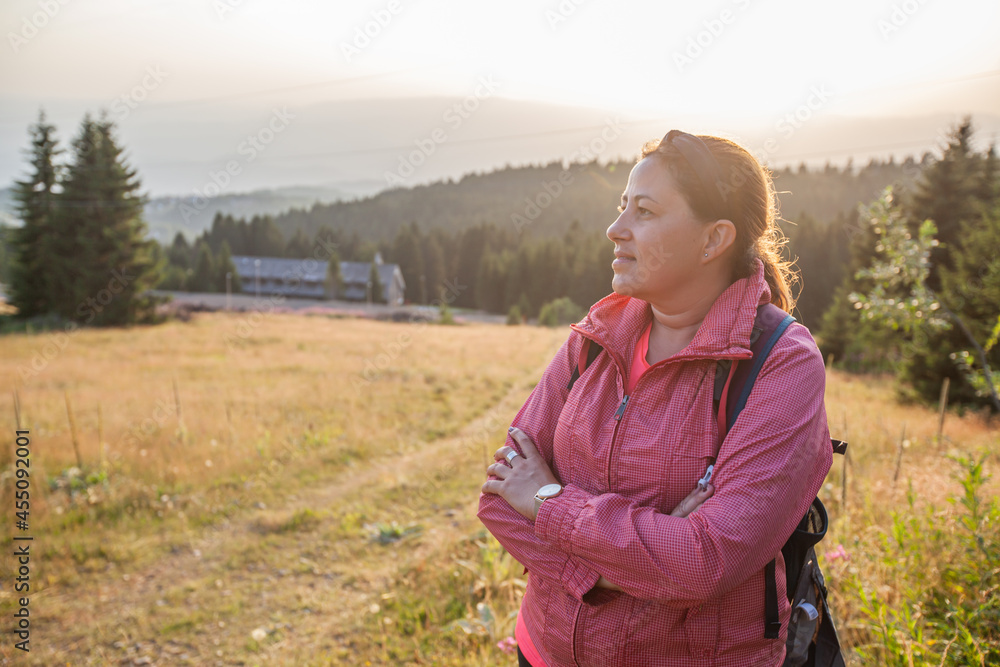 Woman enjoy nature view at sunset.Mountain landscape in background Woman enjoy nature view at sunset.Mountain landscape in background