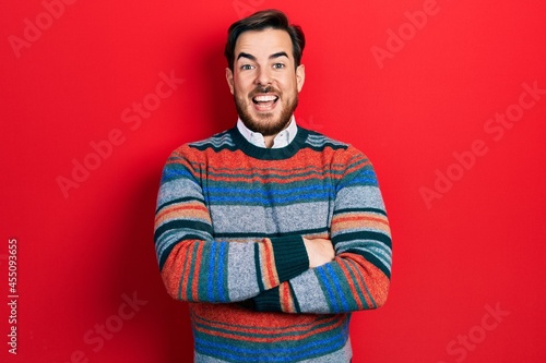 Handsome caucasian man with beard with arms crossed gesture celebrating crazy and amazed for success with open eyes screaming excited. © Krakenimages.com
