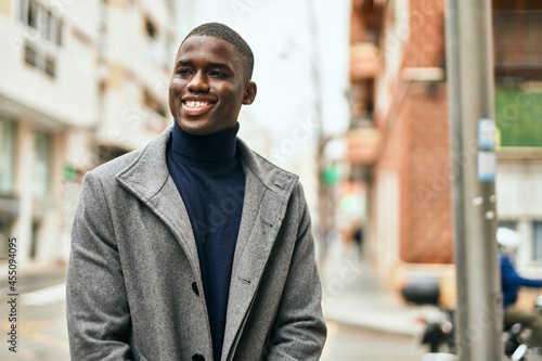 Young african american man smiling happy standing at the city © Krakenimages.com