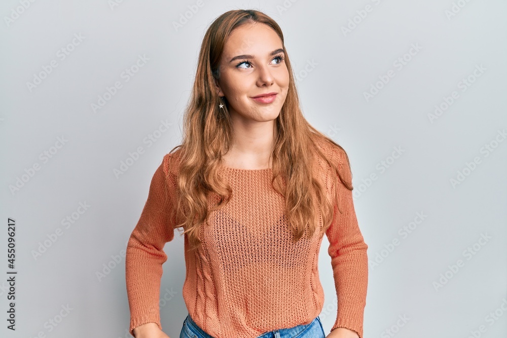 Fototapeta premium Young blonde woman wearing casual clothes looking to side, relax profile pose with natural face and confident smile.