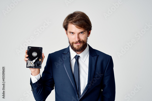 Cheerful business man with hard drive from computer data protection