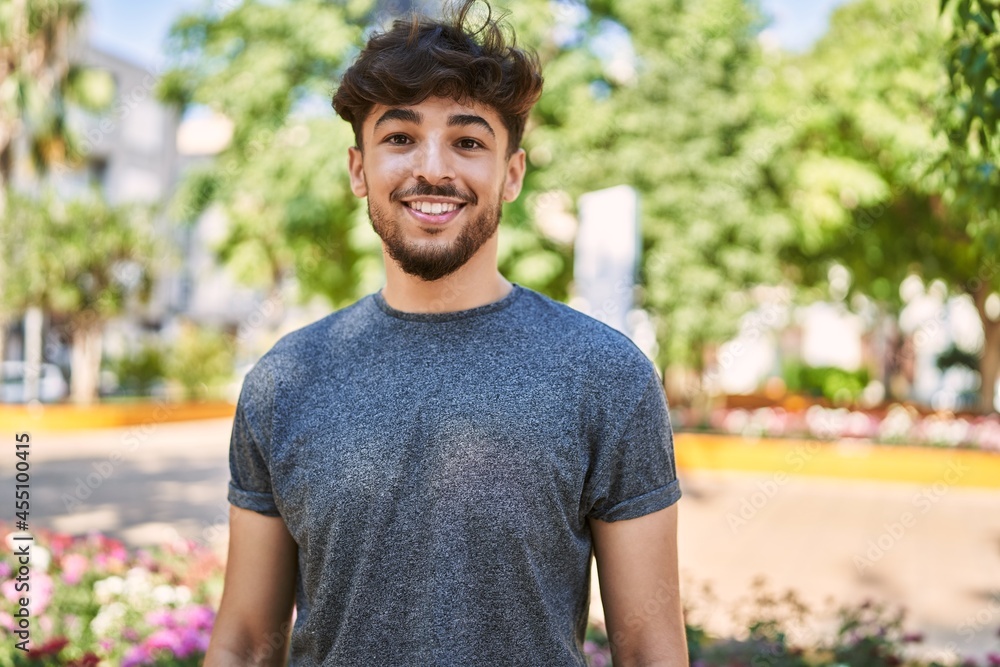 Young arab man smiling happy standing at the city. Young arab man smiling happy standing at the city.