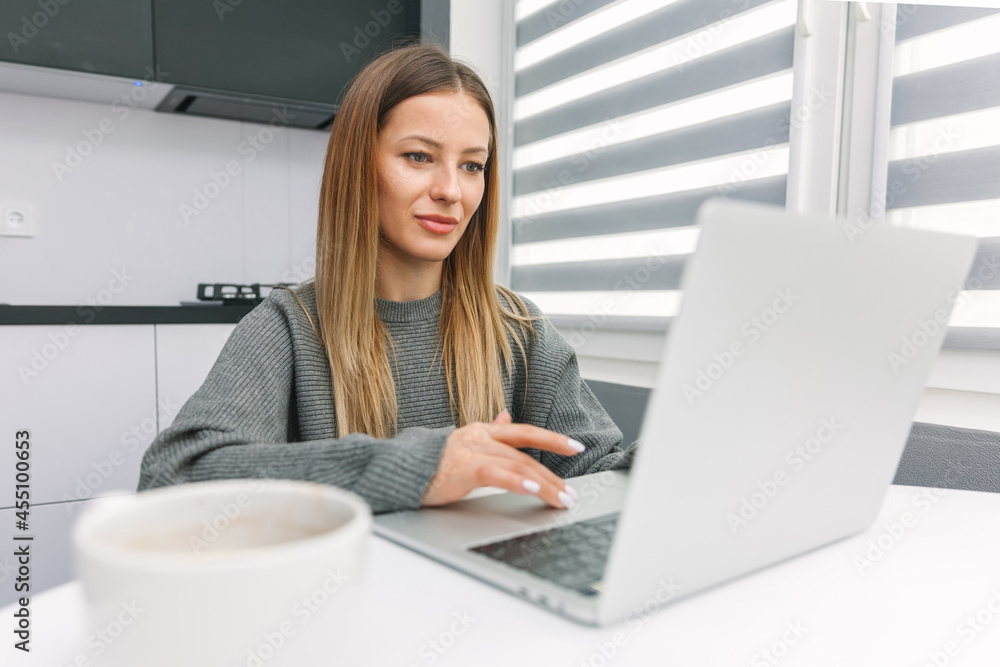 Girl working on laptop at the table Girl working on laptop at the table