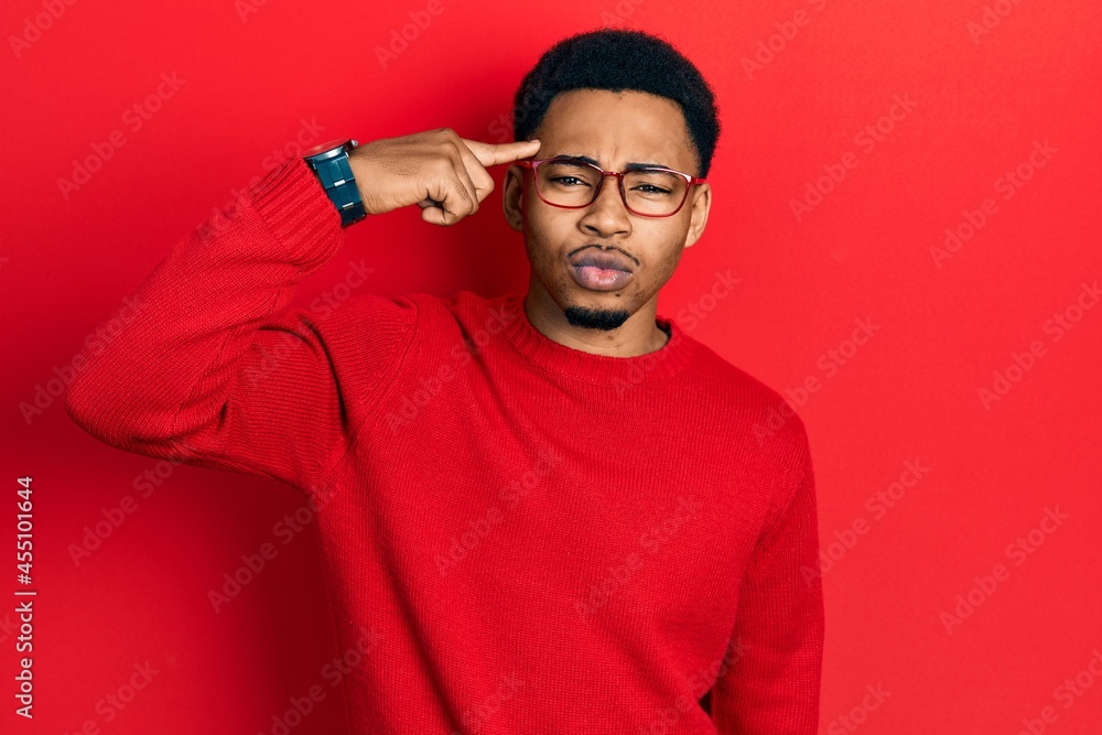 Young african american man pointing head with finger looking at the camera blowing a kiss being lovely and sexy. love expression. Young african american man pointing head with finger looking at the camera blowing a kiss being lovely and sexy. love expression.