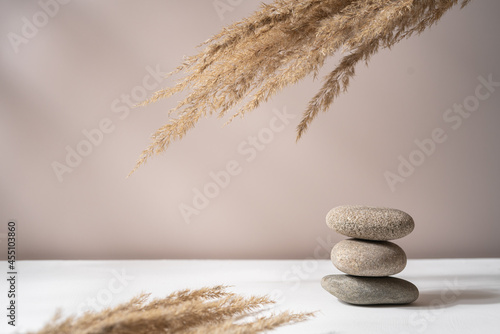 Photography Stones pebble pyramid on white table symbolizing stability; zen; harmony; balance