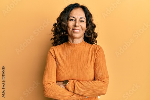Cuadro en lienzo Middle age hispanic woman wearing casual clothes happy face smiling with crossed arms looking at the camera