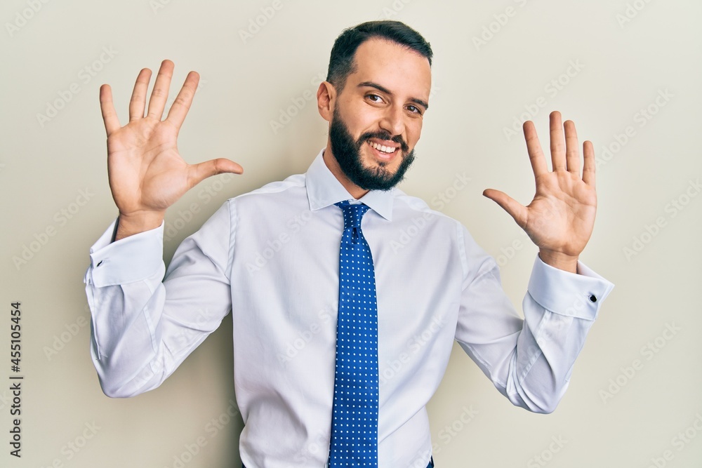 Young man with beard wearing business tie showing and pointing up with fingers number ten while smiling confident and happy. Young man with beard wearing business tie showing and pointing up with fingers number ten while smiling confident and happy.