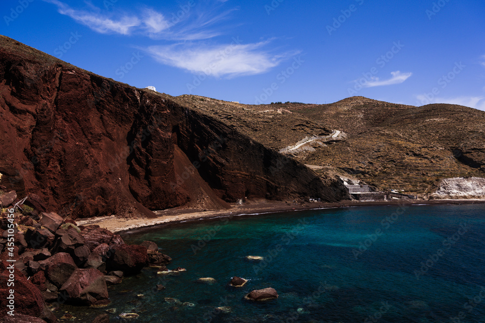 Scenic landscape of red sand beach near Akrotiri village on Santorini island, Greece. Huge stones and rocks. Aegean Sea, Cyclades. Beautiful nature.