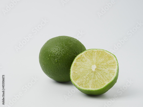 a glass of fresh drinking water and a lime. mineral water as a thirst quencher.