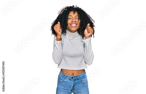 Young african american girl wearing casual clothes excited for success with arms raised and eyes closed celebrating victory smiling. winner concept.