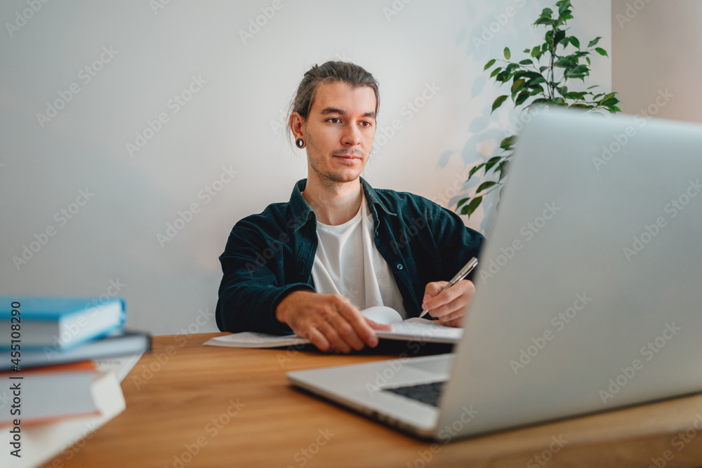 Online student prepare for pass exam to university using laptop. Adult man at college making universitet subjects