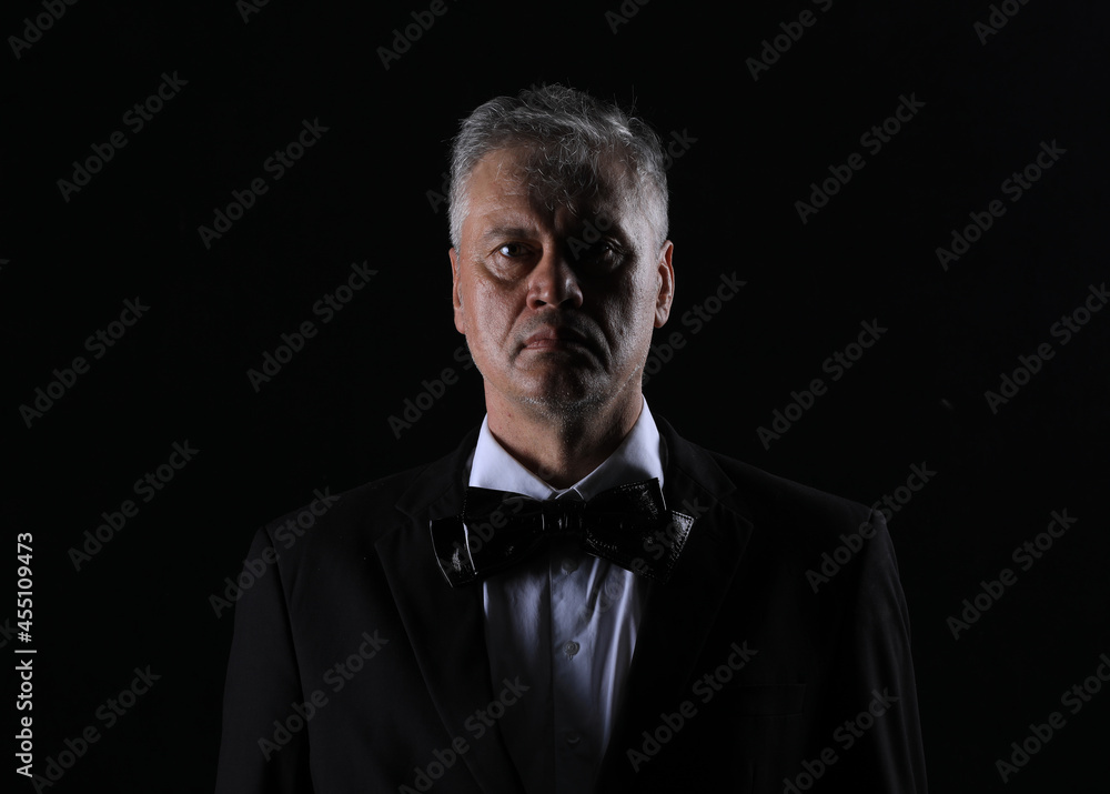 studio dark portrait of a gentleman on a black background studio dark portrait of a gentleman on a black background