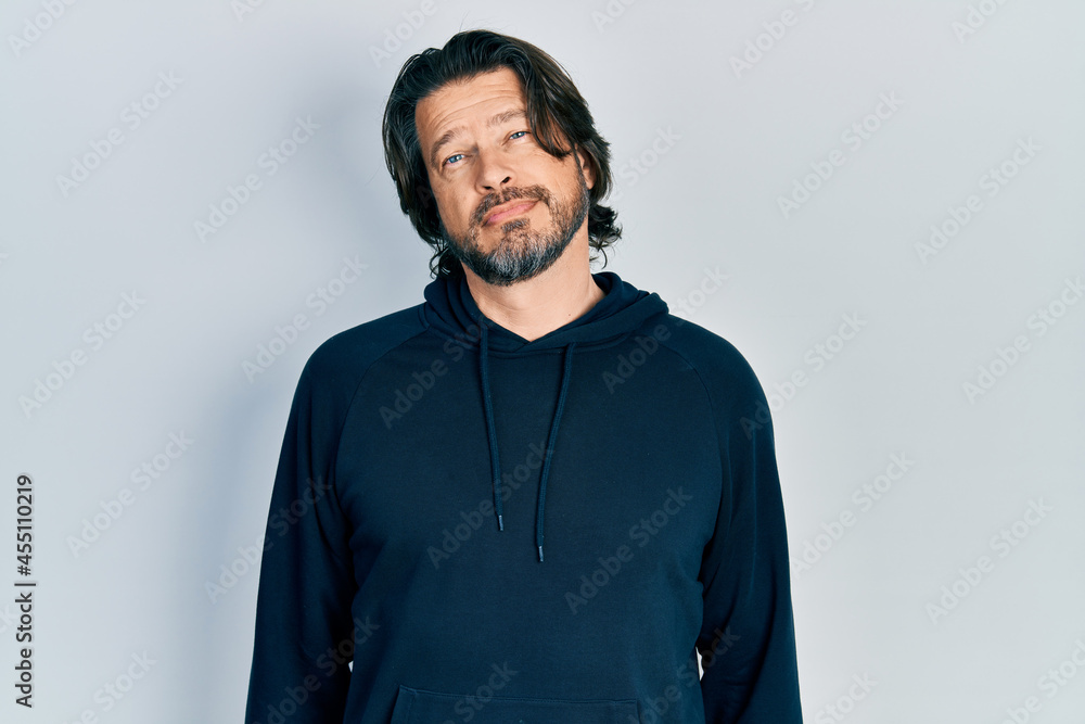 Obraz premium Middle age caucasian man wearing casual sweatshirt relaxed with serious expression on face. simple and natural looking at the camera.