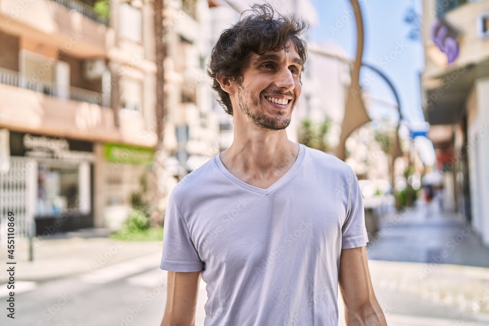 Young hispanic man smiling happy standing at the city. Young hispanic man smiling happy standing at the city.