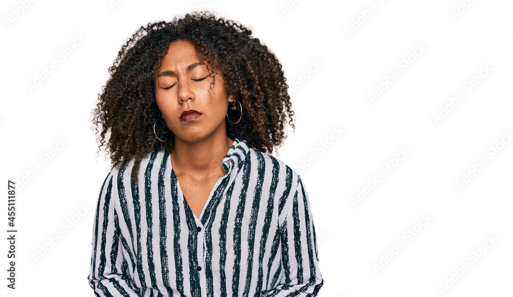 Young african american girl wearing casual clothes with hand on stomach because indigestion, painful illness feeling unwell. ache concept. Young african american girl wearing casual clothes with hand on stomach because indigestion, painful illness feeling unwell. ache concept.