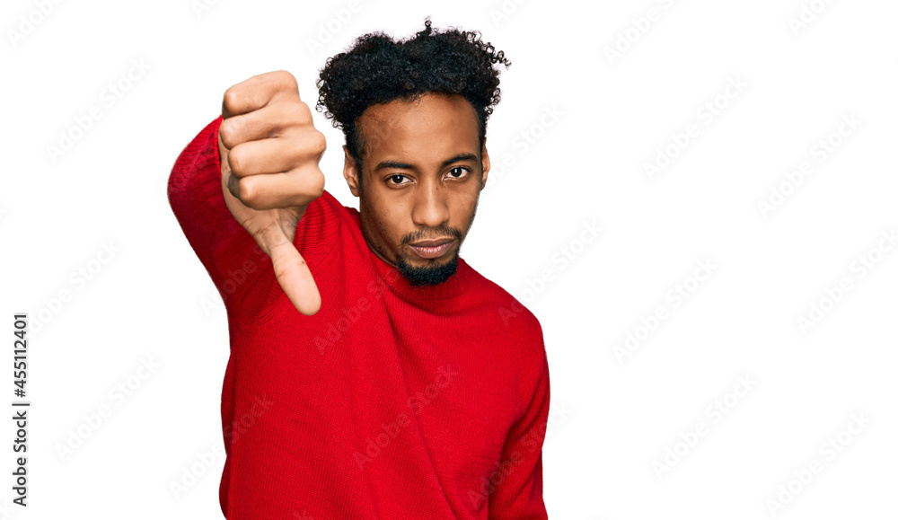 Young african american man with beard wearing casual winter sweater looking unhappy and angry showing rejection and negative with thumbs down gesture. bad expression. Young african american man with beard wearing casual winter sweater looking unhappy and angry showing rejection and negative with thumbs down gesture. bad expression.
