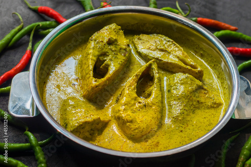 Sorshe Illish or Hilsa fish cooking with mustard seed.famous Bengali food. photo