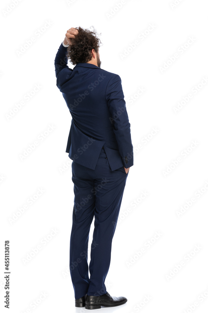 businessman scratching his head and pondering a decision businessman scratching his head and pondering a decision