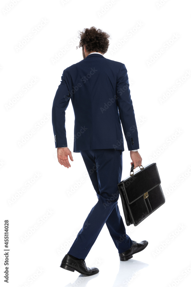 businessman walking one way and looking the other way businessman walking one way and looking the other way