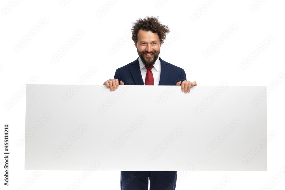 handsome businessman looking at the camera, holding a blank billboard handsome businessman looking at the camera, holding a blank billboard
