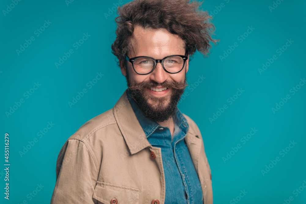 Fototapeta premium enthusiastic unshaved guy with glasses smiling and posing