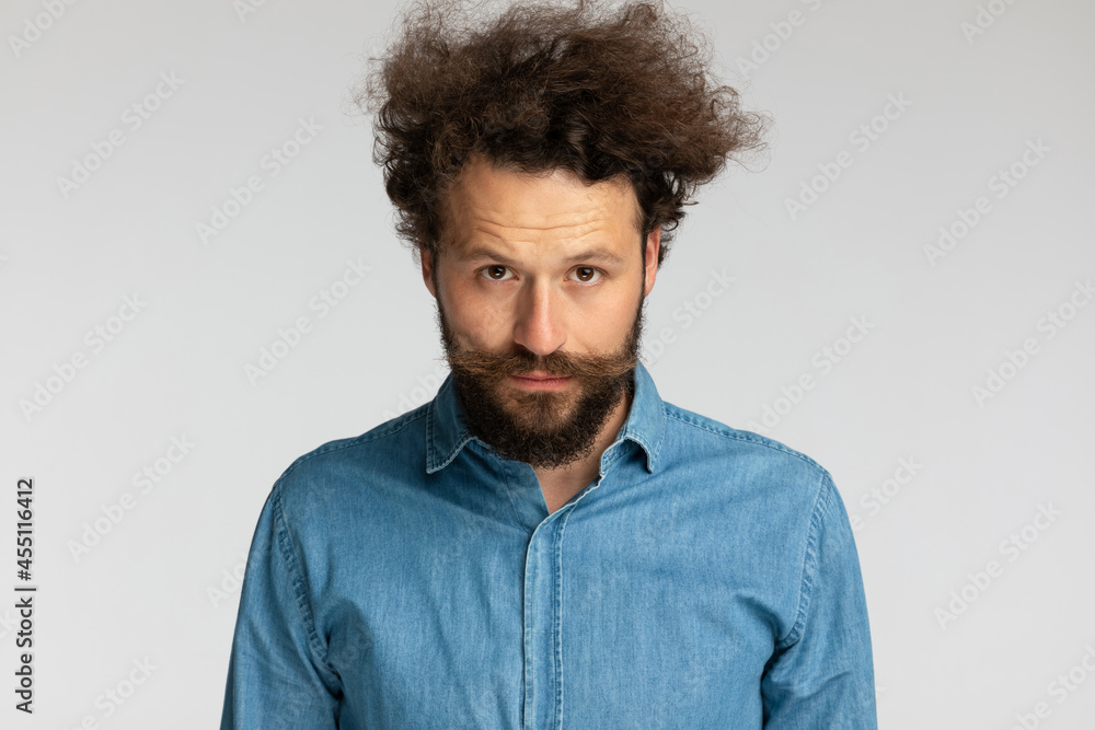portrait of casual unshaved man with curly hair and beard posing portrait of casual unshaved man with curly hair and beard posing