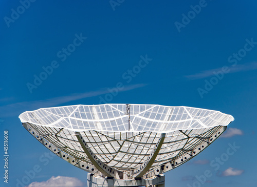 Fototapeta Naklejka Na Ścianę i Meble -  A giant satellite dish for receiving a signal is aimed up to the blue sky.
