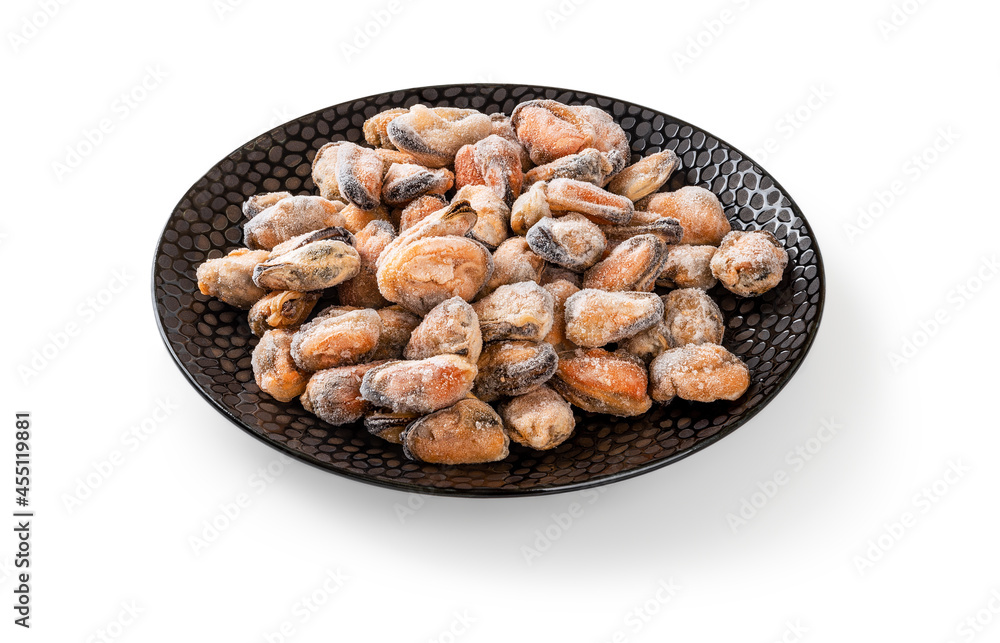 Ised peeled mussel meat on an round black ceramic plate isolated on a white. Cooked mussels as ingredient of omega-3 protein healthy eating and tasty seafood recipes. Frozen shellfish. Ised peeled mussel meat on an round black ceramic plate isolated on a white. Cooked mussels as ingredient of omega-3 protein healthy eating and tasty seafood recipes. Frozen shellfish.