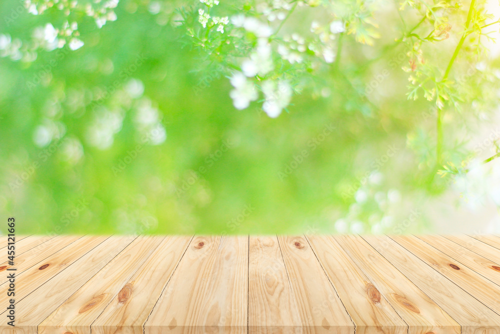 Wood floor with blurred trees of nature park background and summer season, product display montage Wood floor with blurred trees of nature park background and summer season, product display montage