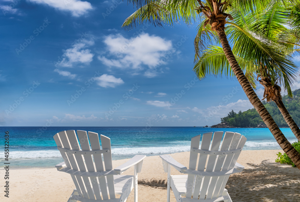 Sandy beach with beach chairs for vacations in tropical island