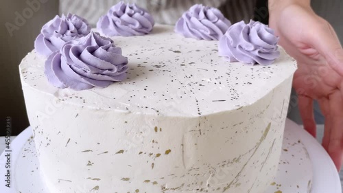 Professional confectioner decorating cake with cream roses. The process of cooking. 4K. Step 2