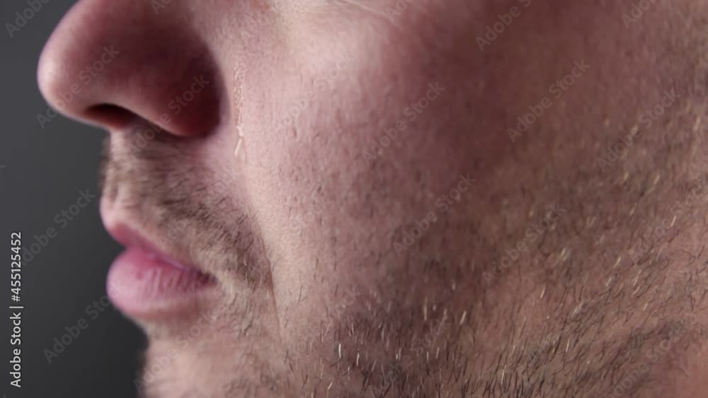 Upset man crying, drop of tear running down her cheek, eye discharge, problems. Pain and suffering concept Upset man crying, drop of tear running down her cheek, eye discharge, problems. Pain and suffering concept