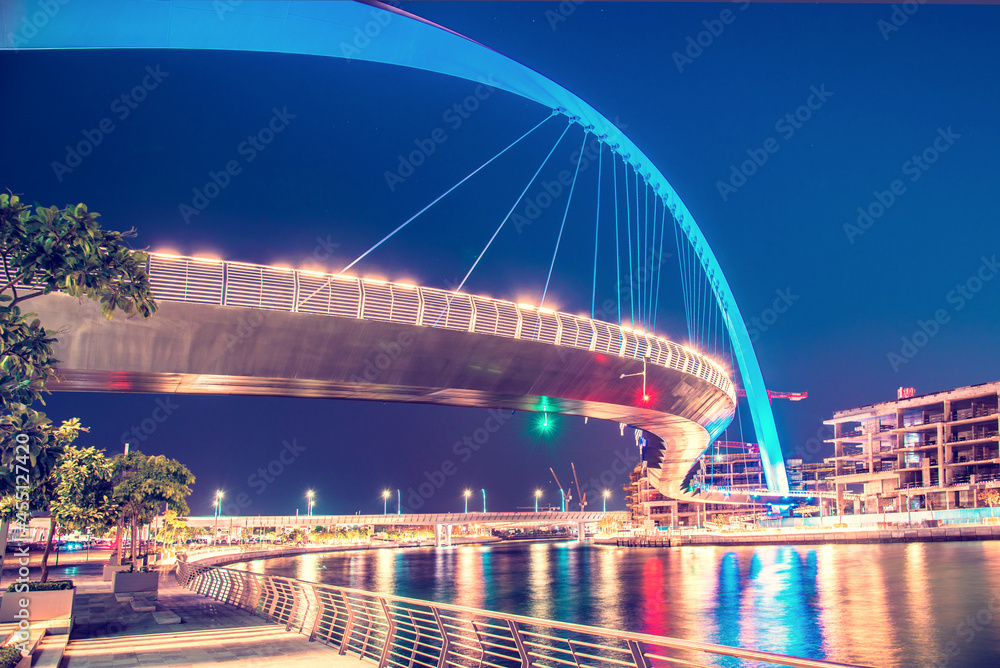 Beautiful incredible cityscape with Tolerance bridge near the water canal in Dubai, United Arab Emirates.