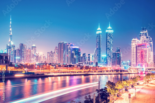 Beautiful incredible cityscape with skyscrapers in the old town next to the Tolerance bridge near the water canal in Dubai, United Arab Emirates.