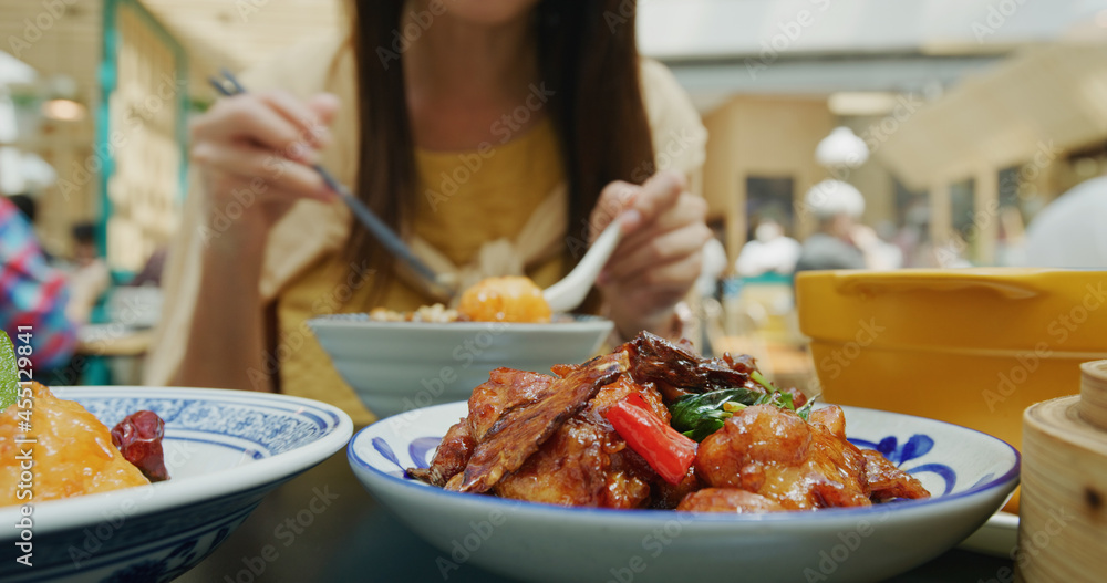 Woman enjoy her meal in chinese style restaurant