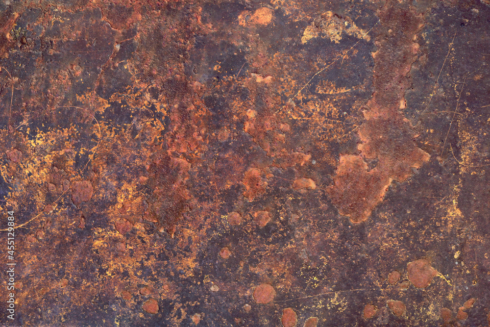 extremely rusty metal surface of a plank, with abstract shappes and forms in orange tones over a dark background - closeup worn texture extremely rusty metal surface of a plank, with abstract shappes and forms in orange tones over a dark background - closeup worn texture