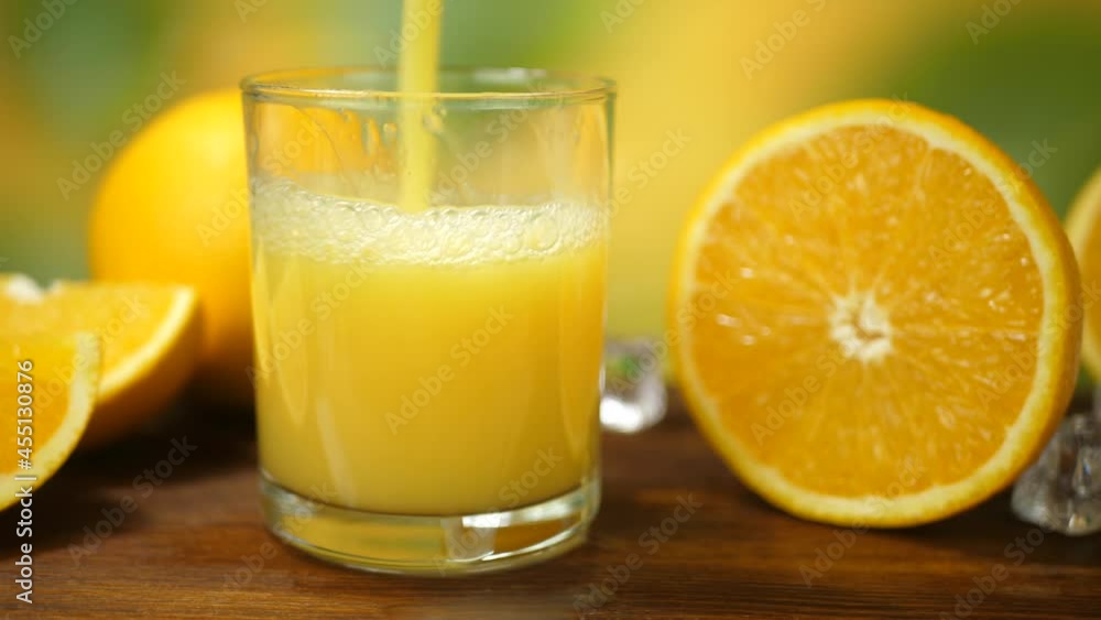 organic fresh orange juice pour into glass with fruit on brown wooden organic fresh orange juice pour into glass with fruit on brown wooden