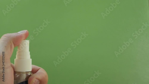 spray bottle given several squirts green background 