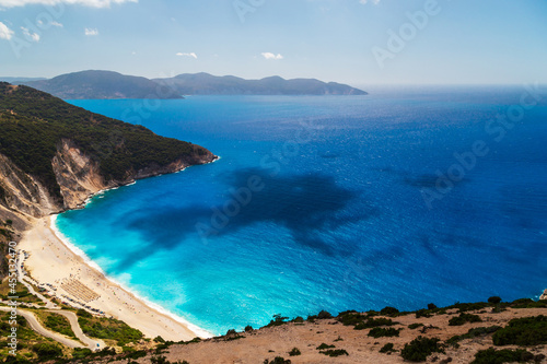 A top view at Myrtos Beach and fantastic turquoise and blue Ionian Sea water. Aerial view, summer scenery of famous and extremely popular travel destination in Cephalonia, Greece, Europe