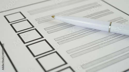  white pen lying on voting ballot paper with vote checkbox place concept