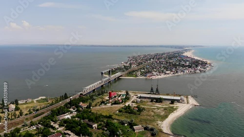 Drone view of Zatoka in Odessa. The bridge stands on the border between the Black Sea and the Belgorod-Dnestrovsky estuary. A bridge between two torn parts of the Budak Spit. Resort town photo